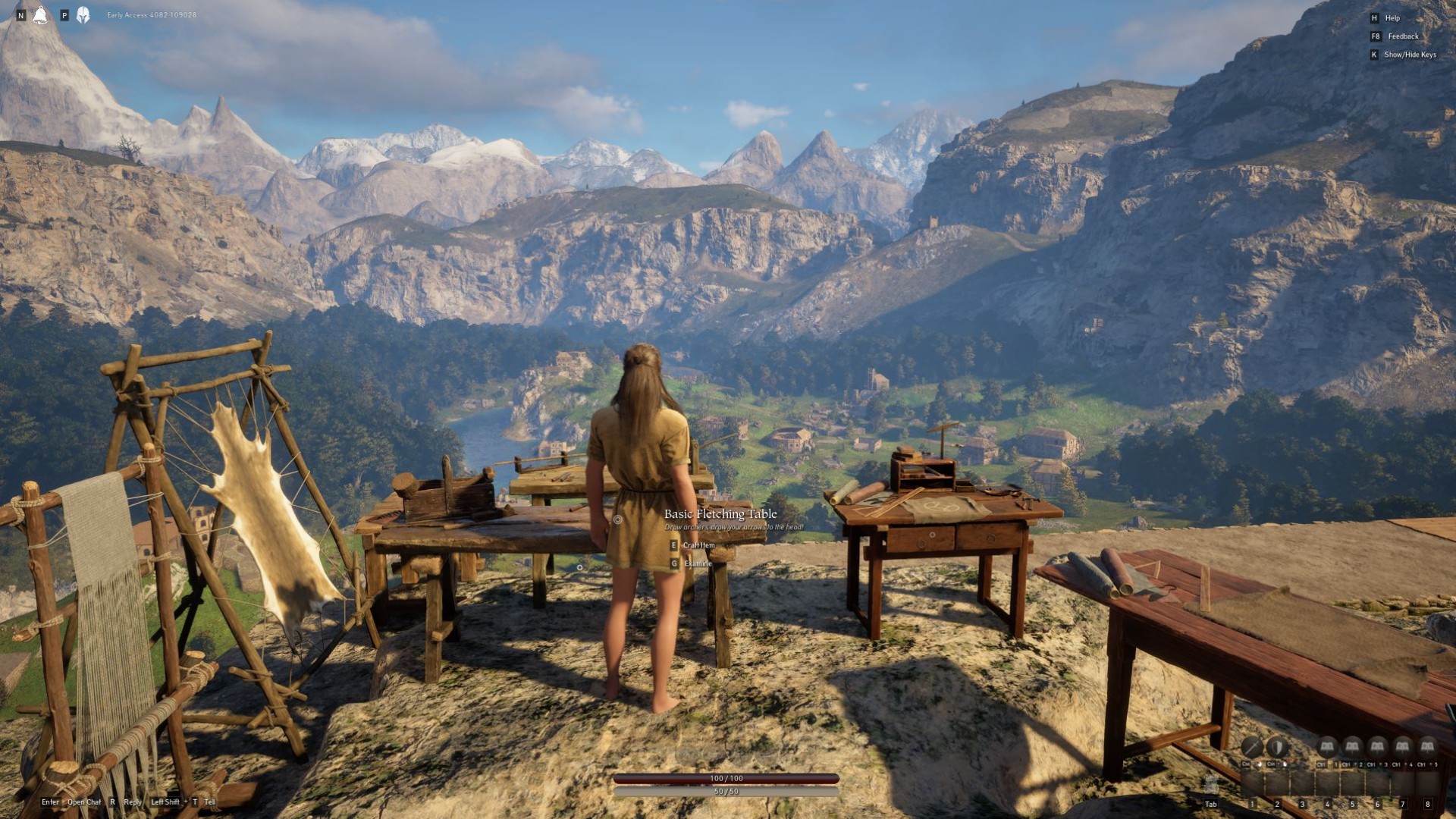 Pax Dei impressions: The player character stands at a crafting bench, looking over a village build in a valley surrounded by mountains.