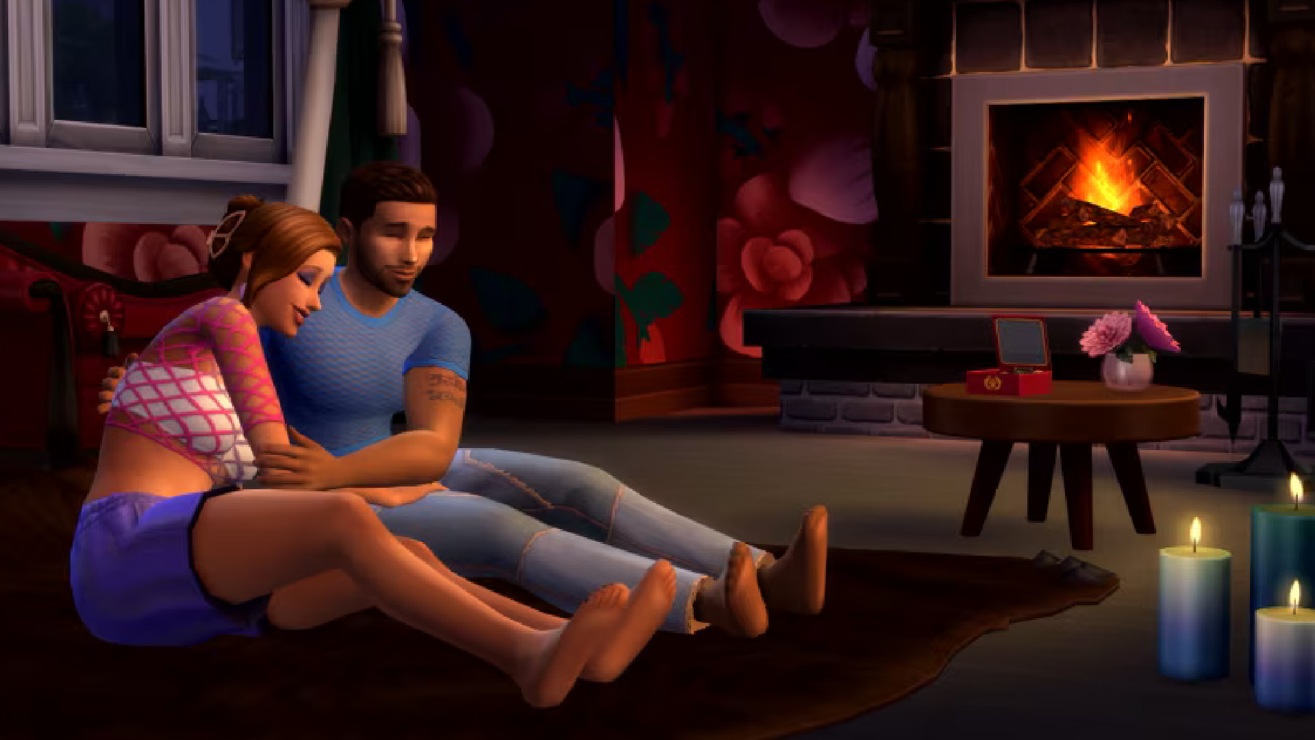 The Sims 4 Lovestruck interview - A couple cuddles in their living room before a roaring fire.