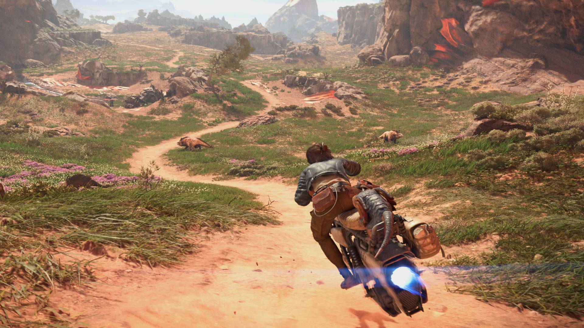 A brown-haired woman wearing a blue leather jacket rides a Star Wars speeder through a canyon area, following a dirt track into the blue sky