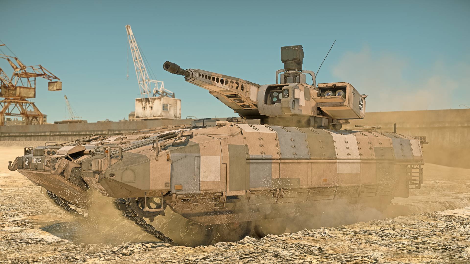 A huge desert tank prepares to fire in a barren area