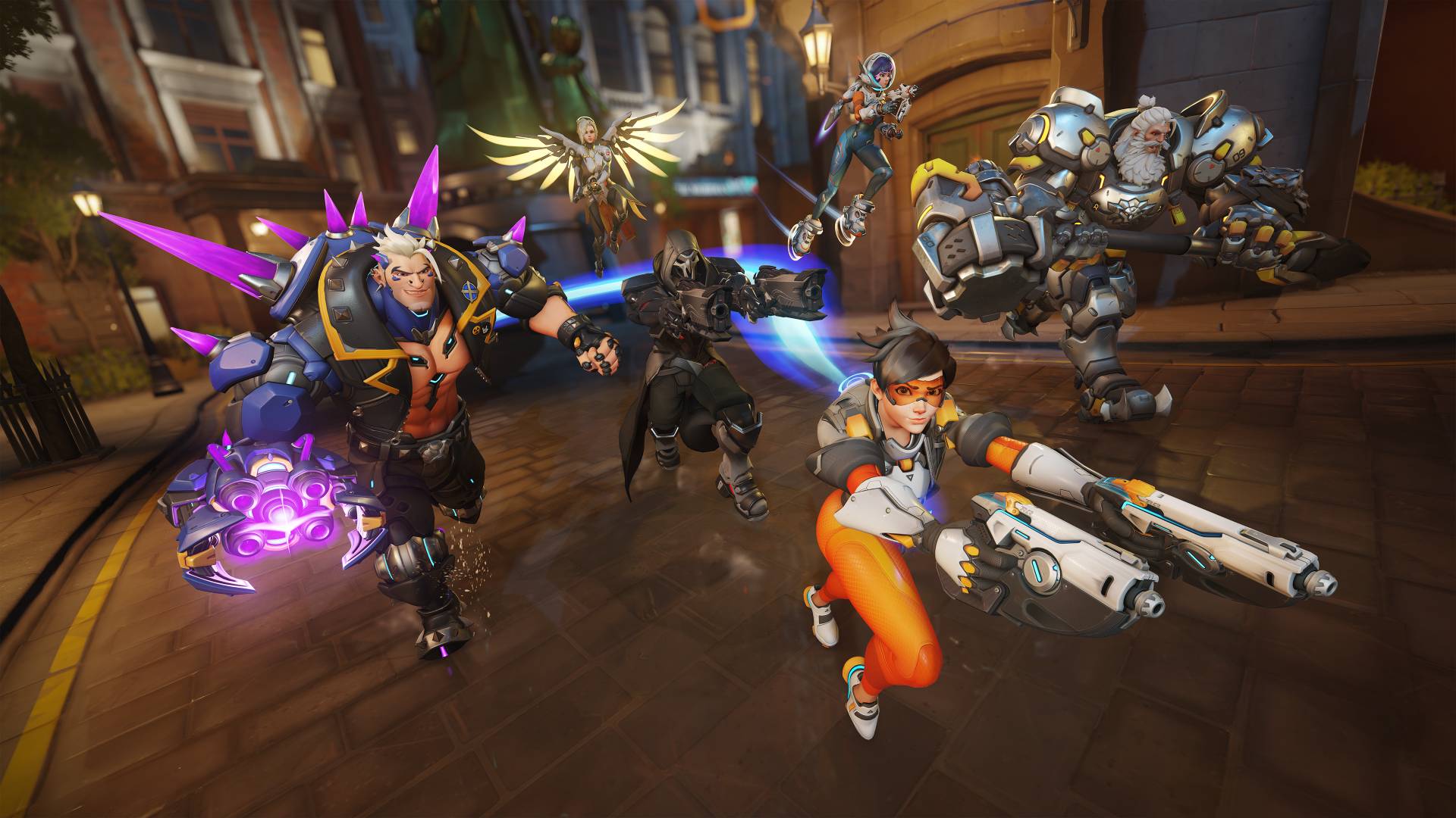 Tracer, Reaper, Mercy, Hazard, Juno, and Reinhardt run down a street preparing for battle