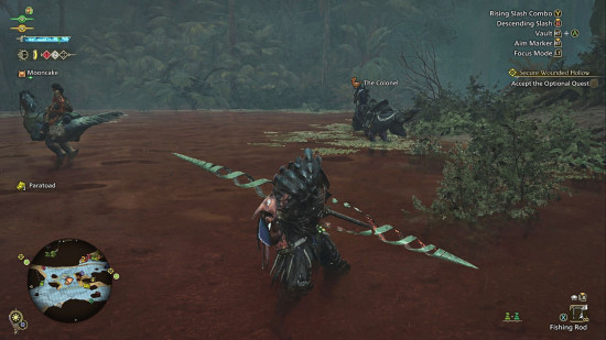 Monster Hunter Wilds Insect Glaive: a man stands calf-deep in a red river, posing with a large spear-like weapon.